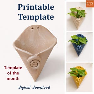 May include: A printable template for a cone-shaped wall planter featuring a spiral accent at the base and two holes at the top for mounting. The image displays the text Printable Template, Template of the month, and digital download.