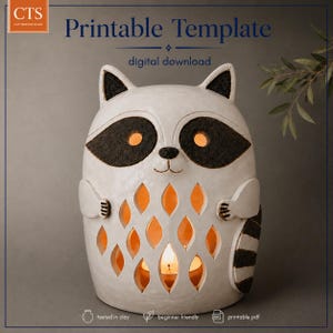 Puede incluir: Una linterna de cerámica blanca con forma de mapache, con parches negros en los ojos y una cola a rayas. El cuerpo tiene recortes en forma de diamante que permiten que brille una luz cálida. El texto superior dice CTS Printable Template.