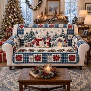 May include: A quilted sofa cover featuring a winter scene with a white polar bear and a penguin wearing red scarves, surrounded by pine trees, snowflakes, and an igloo. The border displays a blue plaid pattern with red poinsettia flower motifs.