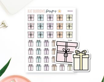 May include: A sticker sheet labeled KAT BURROWS Designs SML022 featuring rows of small gift box stickers in pastel pink, blue, purple, orange, and yellow. Two larger individual gift box stickers in pink and yellow are placed over the sheet.