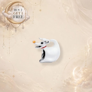 May include: A silver-toned charm shaped like a ghost dog with a white body, a red collar, and a small orange nose. The charm features a stylized, smooth design with a curved tail and an open mouth. A circular graphic above reads BUY 2 GET 1 FREE.