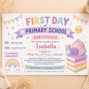 May include: A rectangular certificate titled First Day of Primary School for Isabella, dated 19th August 2026. The design features colourful bunting, a smiling sun, a rainbow with clouds, a stack of books, a pencil holder, and a backpack.