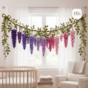 May include: A crocheted wisteria garland featuring a gradient of hanging flower clusters in shades of deep purple, lavender, magenta, and soft pink, accented with green crocheted leaves and vines, finished with a bow at each end of the strand.