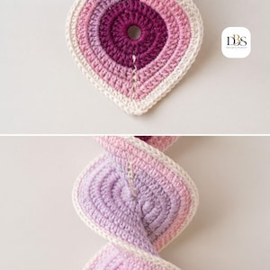 May include: A crochet spiral ornament featuring a gradient of purple, pink, and cream yarn. The top section shows a flat, circular, teardrop-shaped piece with a center hole. The bottom section shows the piece twisted into a spiral. Text reads DBS.