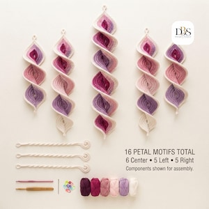 May include: A crochet kit featuring five spiral petal motifs in shades of pink, purple, and cream. Includes three twisted cords, two crochet hooks, a needle, stitch markers, and six yarn skeins. Text reads: 16 PETAL MOTIFS TOTAL 6 Center 5 Left 5 Right.
