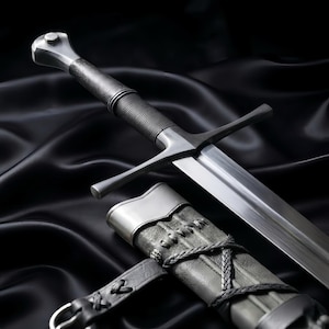 May include: A silver-toned steel sword featuring a straight, double-edged blade, a crossguard, and a cylindrical grip with fine horizontal ridges. The sword is accompanied by a textured grey scabbard with braided leather lacing and a metal fitting.