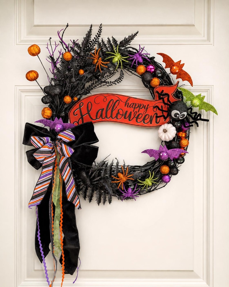Bright Halloween wreath with bats, spiders and a Happy Halloween sign