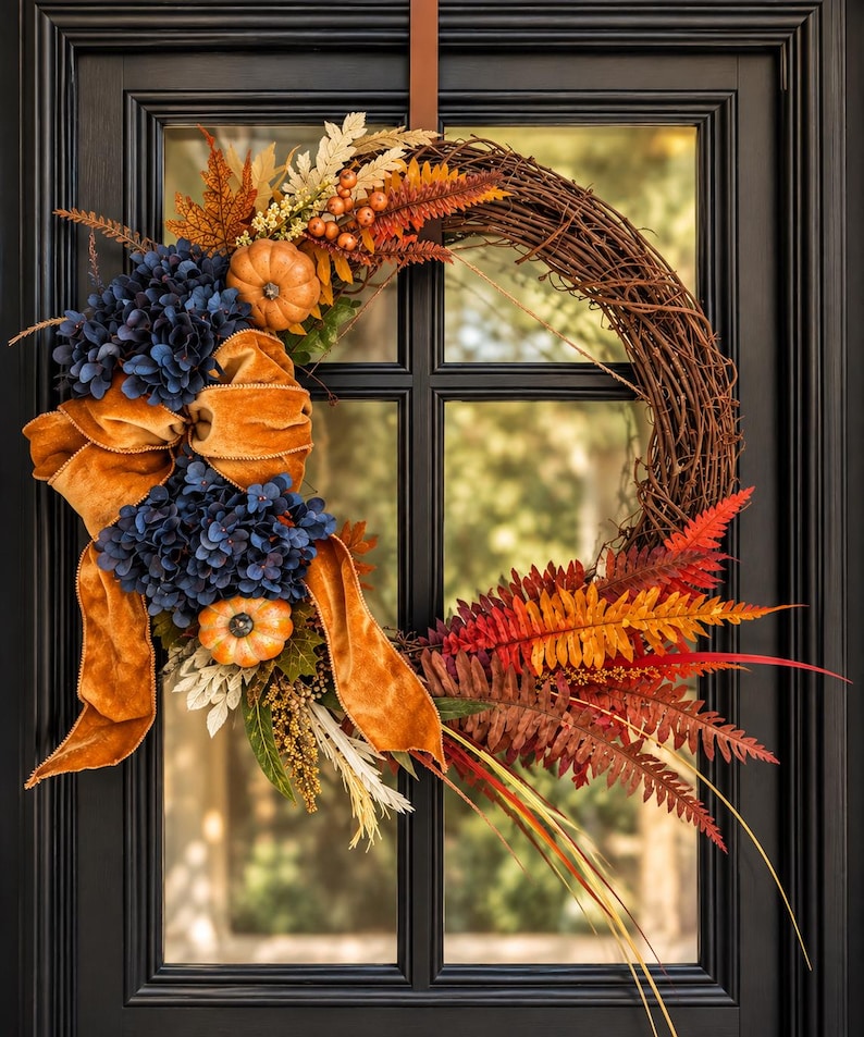 Fall wreath with navy hydrangeas, mini pumpkins and a burnt orange velvet bow