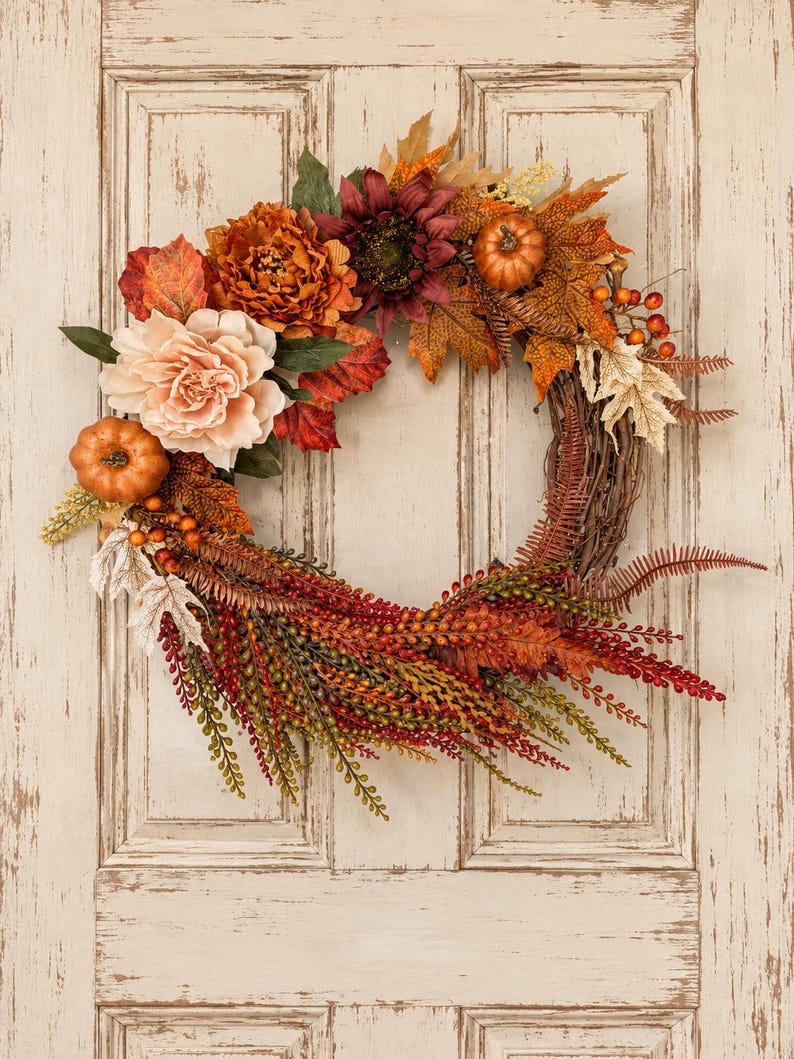 Autumn wreath with rust and burgundy peonies, mini pumpkins and a berry cascade