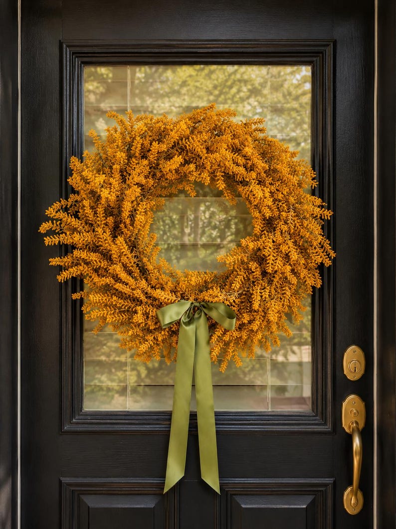 Modern minimalist fall wreath in mustard gold fern with a sage green bow
