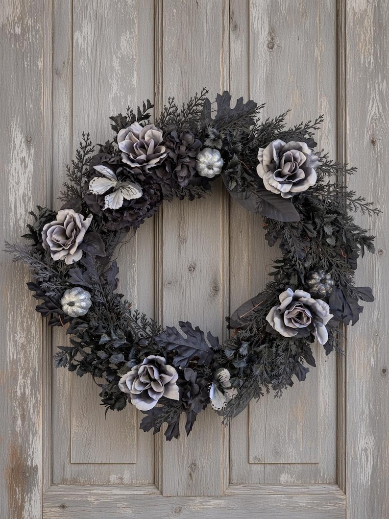 Elegant gothic wreath with grey and black roses, butterflies and silver glitter pumpkins