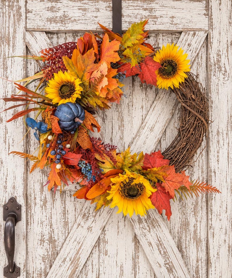 Sunflower fall wreath with a navy blue pumpkin and navy berry clusters