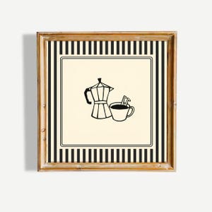 May include: A square framed wall art piece featuring a cream-colored center with a black line drawing of a moka pot and a coffee cup with a spoon. The design is bordered by a black and cream vertical striped pattern within a wooden frame.