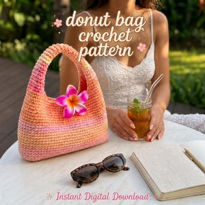 May include: A crochet handbag featuring a gradient of pink and orange yarn, adorned with a single pink and yellow plumeria flower. The text "donut bag crochet pattern" and "Instant Digital Download" are visible in the image.
