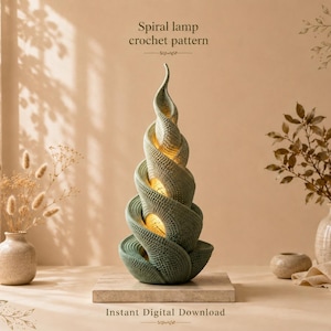 May include: A sage green spiral lamp crochet pattern featuring a tall, twisting, textured structure with a warm, glowing light emanating from within. The text "Spiral lamp crochet pattern" and "Instant Digital Download" are visible.
