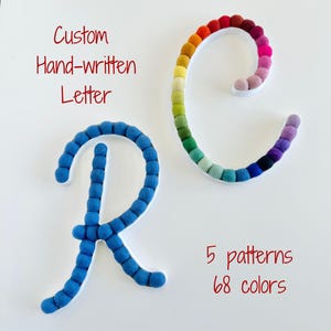 May include: Two cursive letters, R and C, constructed from small felt pom-poms. The letter R is solid blue, while the letter C features a rainbow gradient. Text reads: Custom Hand-written Letter, 5 patterns, 68 colors. The letters have white borders.