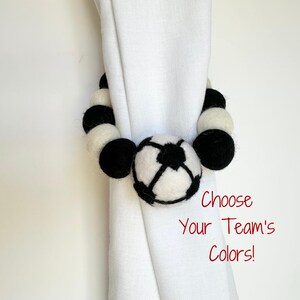 May include: Black and white felt ball curtain tiebacks with a soccer ball design. Choose Your Team's Colors!