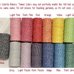May include: Assortment of baker's twine in various colors, including black, gray, light pink, dark pink, red, orange, yellow, light green, light purple, dark purple, indigo, blue, and dark green. The twine is wound around spools.