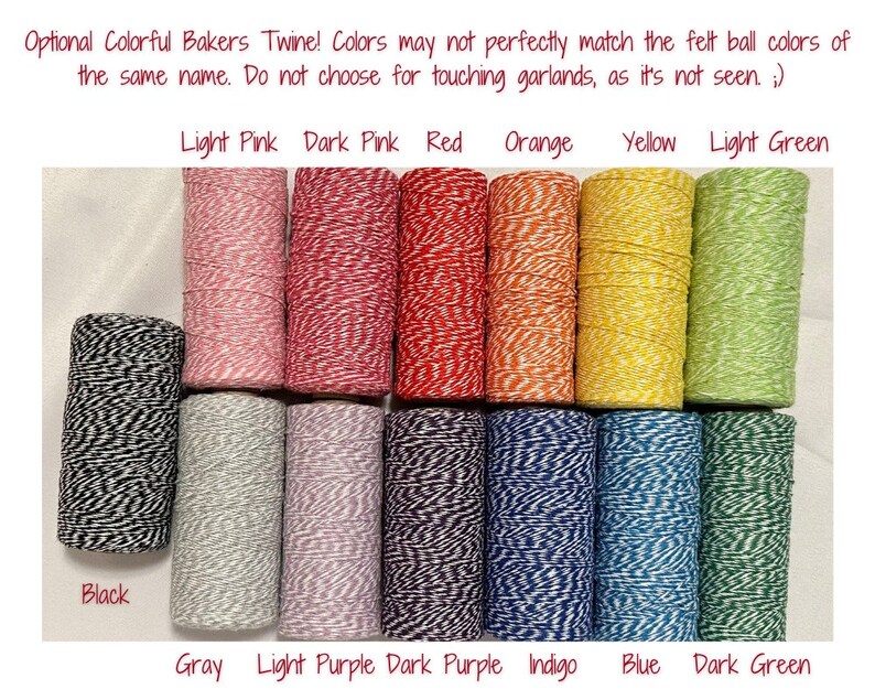 May include: Assortment of baker's twine in various colors, including black, gray, light pink, dark pink, red, orange, yellow, light green, light purple, dark purple, indigo, blue, and dark green. The twine is wound around spools.