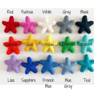 May include: A collection of 15 felt star shapes in various colors, including red, fuchsia, white, gray, black, pumpkin, gold, yellow, emerald, turquoise, lilac, sapphire, French blue, blue gray, and teal.