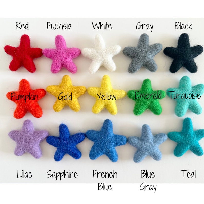 May include: A collection of 15 felt star shapes in various colors, including red, fuchsia, white, gray, black, pumpkin, gold, yellow, emerald, turquoise, lilac, sapphire, French blue, blue gray, and teal.