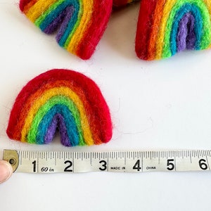 May include: A rainbow-coloured felt rainbow measuring 5 cm wide. The rainbow is made of felt and is a bright, cheerful colour.