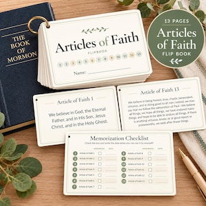 Könnte beinhalten: Ein Flipbook mit dem Titel Articles of Faith und einem goldenen Ringbuchmechanismus, bestehend aus dreizehn nummerierten Seiten, einer Checkliste zum Auswendiglernen und einzelnen Karten für Artikel 1 und 13 auf cremefarbenem Karton mit grünen Akzenten.