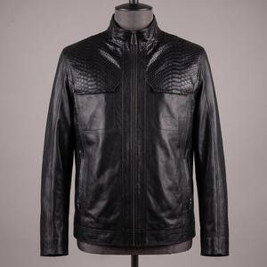 May include: A black jacket featuring a full-length front zipper, a stand-up collar, and textured snake-skin pattern panels across the upper chest and shoulders. The garment is constructed with smooth leather panels on the lower body and sleeves.