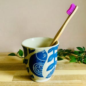 Handmade stoneware sgraffito blue and white bird toothbrush holder
