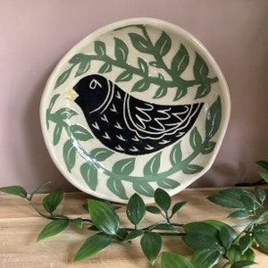 Handmade stoneware sgraffito black bird and leaf bowl