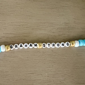 Graham Strong – Perlenarmband – Schmuck zur Unterstützung und Sensibilisierung für Kinderkrebs