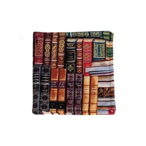 May include: A close-up of a fabric pot holder with a pattern of vintage books. The books have gold lettering and ornate designs on their spines. The pot holder is brown, red, and gold.