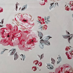 May include: A beige fabric with a pink and grey floral pattern. The fabric features large pink roses with grey leaves and smaller pink berries.