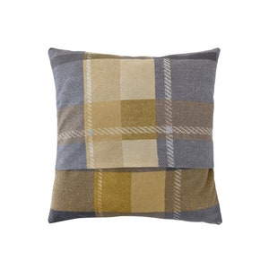 May include: A square throw pillow with a plaid pattern in shades of yellow, brown, and gray.