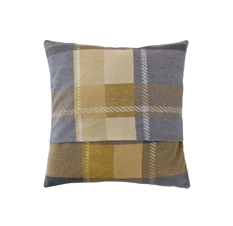 May include: A square throw pillow with a plaid pattern in shades of yellow, brown, and gray.
