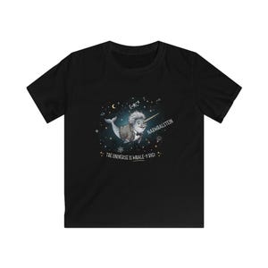 May include: A black short-sleeve t-shirt featuring a graphic of a narwhal with wild hair and a suit, labeled Narwhalstein. The design includes the text E=MC2 and The Universe is Whale-y Big, surrounded by stars, planets, and scientific symbols.