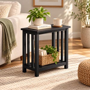May include: A rectangular black wooden side table with a slatted frame design and a lower shelf. The top surface holds a potted green plant and a ceramic mug on a coaster, while the lower shelf contains a woven basket with a green plant.