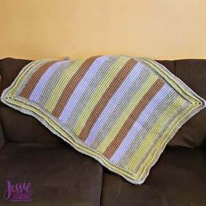 May include: A striped crocheted blanket with a double border in a light gray, lavender, yellow, and brown color scheme.