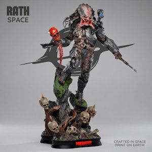May include: A detailed Predator figurine standing on a rocky base adorned with skulls. The creature features dreadlocks, metallic armor, a shoulder-mounted cannon, and holds a red skull with a spinal column. Text reads RATH SPACE and PREDATOR.