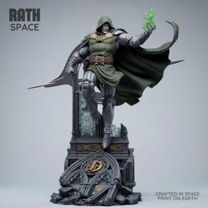 May include: A Doctor Doom figurine featuring a metallic silver suit, a dark green hooded cape, and a brown belt. The character holds a translucent green energy effect. The base is a dark, gothic-style structure with the text RATH SPACE and CRAFTED IN SPACE PRINT ON EARTH.