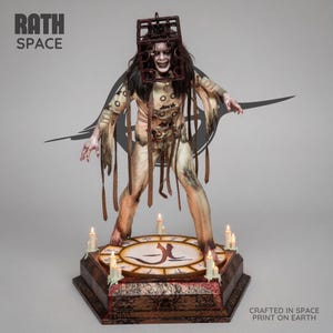 May include: A detailed figurine of a figure wearing a cage-like headpiece and a beige, tattered garment with straps. The figure stands on a circular base featuring symbols and lit candles. Text on the image reads RATH SPACE and CRAFTED IN SPACE PRINT ON EARTH.