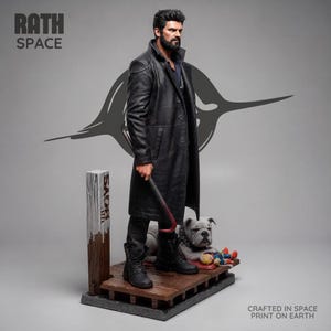 May include: A collectible figurine of a bearded man in a long black coat and black boots, holding a crowbar. He stands on a wooden platform next to a bulldog and a small doll. Text on the image reads RATH SPACE and CRAFTED IN SPACE PRINT ON EARTH.