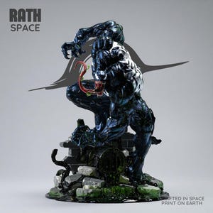 May include: A detailed figurine of the character Venom in a crouching pose, featuring a glossy dark blue and black muscular body, a white spider emblem on the chest, and a long red tongue. The base includes gray stone rubble and green slime.