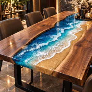 Puede incluir: Una mesa de comedor de madera con borde natural y una incrustación central de resina que imita una playa con agua azul, olas de espuma blanca y una orilla de arena dorada. La mesa se apoya sobre patas de metal de color negro.