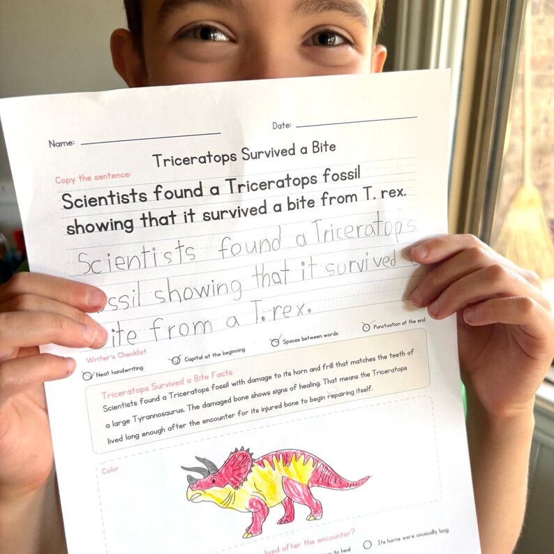 May include: A white educational worksheet titled Triceratops Survived a Bite, featuring a printed sentence about a fossil, a section for handwriting practice, a writer's checklist, and a colored drawing of a red and yellow Triceratops dinosaur.