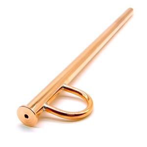 May include: A polished copper-colored metal drinking straw featuring a circular loop handle attached near the mouthpiece. The straw has a smooth, reflective surface and a circular opening at the end, designed for sipping beverages from a container.