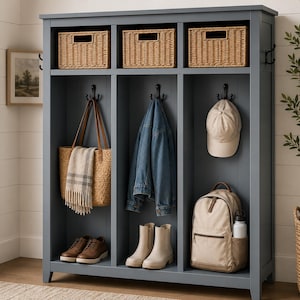 May include: A slate blue hall tree featuring three open storage compartments, each with a top shelf holding a woven wicker basket. The unit includes black metal hooks for hanging items, with a tote bag, denim jacket, and baseball cap displayed.