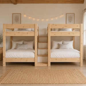 May include: Two light-colored wooden bunk beds connected by a central staircase. Each bed features white bedding, two white pillows, and one small square pillow with a gray geometric pattern. The structure is made of natural pine wood.