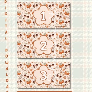 May include: Three rectangular envelope inserts featuring a repeating pattern of orange pumpkins, mouse ears, and coffee cups on a light background. Each insert displays a large, centred, flower-shaped badge with the numbers 1, 2, and 3 respectively.