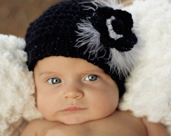 Crochet baby hat with flower and feathers